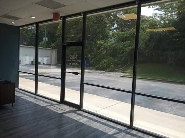 Office building with clear glass facade and heavy sun glare
