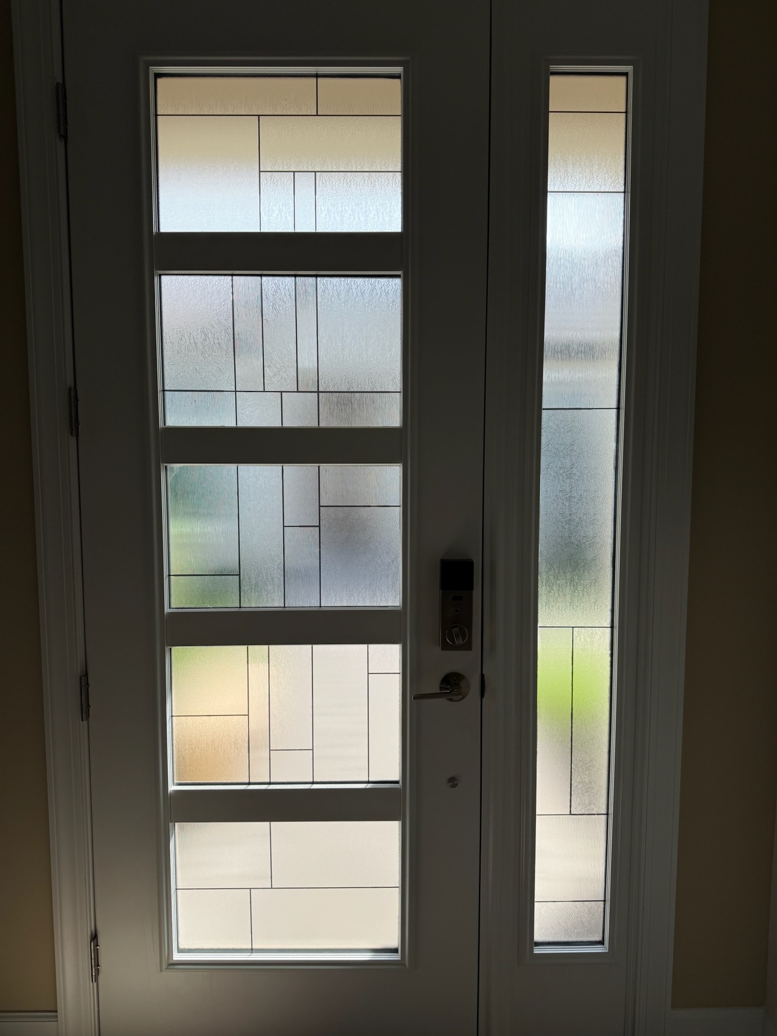 Frosted decorative film panels on a residential front entry door